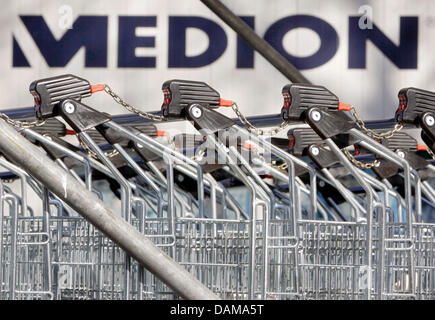 A file picture taken on 23 March 2006 shows shopping carts next to the logo of electronics company Medion in Essen, Germany. The Aldi sub-supplier Medion might soon be in Chinese hands: Computing company Lenovo offers 629 million Euro for Medion. Medion is known for it's computers, cameras and navigation tools which are sold at the retailer Aldi. Photo: Bernd Thissen Stock Photo