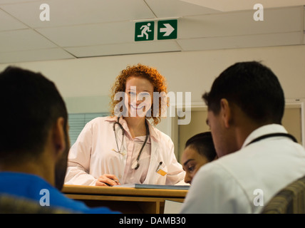Doctor talking to hospital staff at front desk Stock Photo
