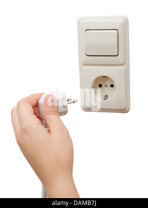 Hand connecting a plug to a socket Stock Photo