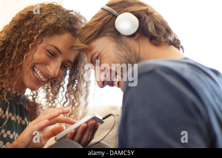 Smiling couple listening to headphones Stock Photo
