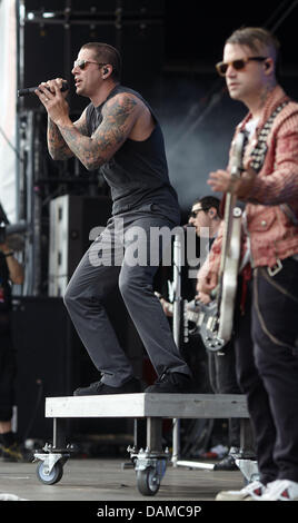 Matthew Charles Sanders (L), frontman of the US metal band Avenged Sevenfold  and (L) bassist Johnny Christ perform at the festival Rock am Ring (Rock at the Ring) at the Nuerburgring, Germany, 05 June 2011. Organisers expect around 85,000 visitors to attend the three day festival on the race track in the Eifel. Photo: Thomas Frey Stock Photo