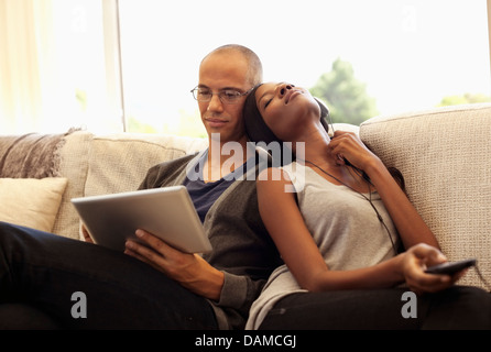 Couple relaxing together on sofa