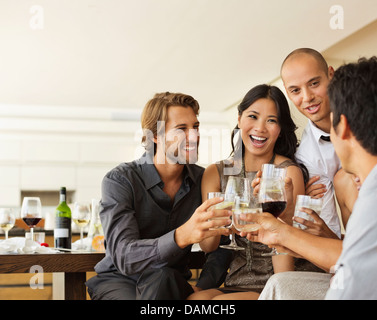 Friends toasting each other at party Stock Photo