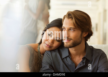 Couple hugging indoors Stock Photo