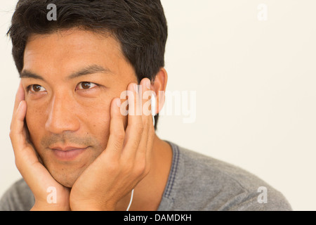 Man resting chin in hands Stock Photo