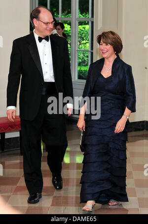 United States Senator Amy Klobuchar (Democrat of Minnesota) and her husband, John Bessler, arrive for a State Dinner in honor of Chancellor Angela Merkel of Germany at the White House in Washington, D.C. on Tuesday, June 7, 2011. Sen. Klobuchar proudly boasted she spent $170.00 blue dress and jacket she wore and another $29.00 on her shoes. Credit: Ron Sachs / CNP Stock Photo