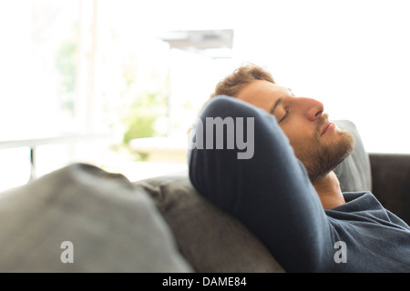 Man relaxing on sofa Stock Photo