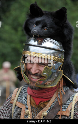 A lay actor wears an ancient Roman military garment and helmet during the 'Germanen- und Roemertage', (Germanic tribes and Romans festival) in Kalkriese, Germany, 12 June 2011. Visitors from all around Germany are visiting the event on the premises of the 'Varusschlacht Museum', which deals with the ancient battle of the Teutoburg Forest between Germanic tribes and the Roman army.  Stock Photo