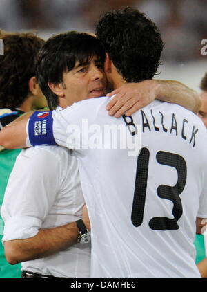 (dpa file) - A file picture dated 25 June 2008 of Michael Ballack (R) hugging Joachim Loew in Basel, Switzerland. According to the German Football Association (DFB), Michael Ballack will not be part of the German national team anymore. After talks with Ballack, national coach Joachim Loew plans without the long-time leader of the national team. But the 34-year-old Ballack is to hav Stock Photo