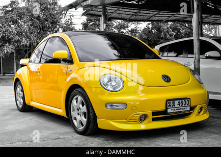 Volkswagen Beetle new style yellow modern VW motorcar. Thailand S. E. Asia Stock Photo