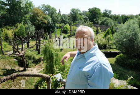 Zoo director Dr. Joerg Junhold stands in front of an outdoor enclosure for apes in the area of Pongoland inside the zoo in Leipzig, Germany, 3 June 2011. The Pongoland, existing for 10 years now, was built in a joint project with the Max-Planck-association and is used to investigate the behaviour of apes.  The zoo was founded in 1878. Within the project Zoo of future the zoo aims t Stock Photo