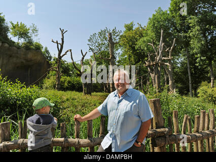 Zoo director Dr. Joerg Junhold stands in front of an outdoor enclosure for apes in the area of Pongoland inside the zoo in Leipzig, Germany, 3 June 2011. The Pongoland, existing for 10 years now, was built in a joint project with the Max-Planck-association and is used to investigate the behaviour of apes.  The zoo was founded in 1878. Within the project Zoo of future the zoo aims t Stock Photo