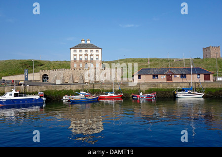 Eyemouth harbour in East Lothian Scotland with Gunsgreen House and vessels moored Stock Photo