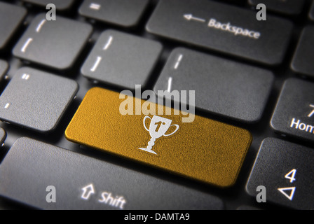 Entertainment key with Trophy icon on laptop keyboard. Included clipping path, so you can easily edit it. Stock Photo