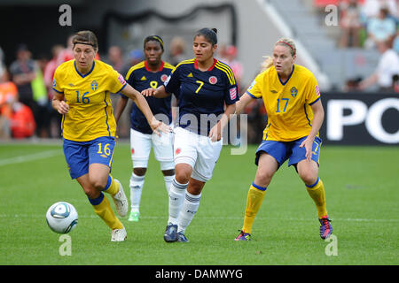 Sweden's Linda Forsberg (L) and Lisa Dahlkvist (R) vie for the ball with Colombia's Catalina Usme  (C)  during the preliminary round of the FIFA Women's soccer world cup match between Colombia and Sweden in Leverkusen, Germany, 29 June 2011. Photo: Revierfoto Stock Photo