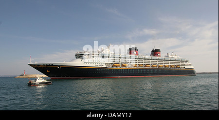 Disney Cruise Line Cruise Ship “Disney Magic” (294 mtrs) - at late afternoon departing - with PRACTICOS / Port Pilot Boat escort Stock Photo