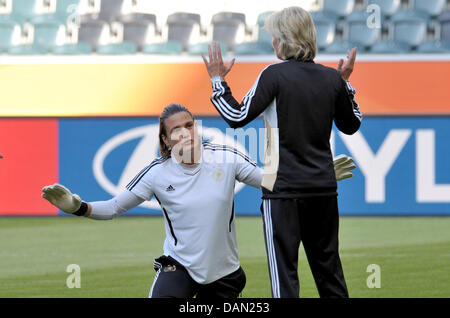 Coach of the German women's national soccer team, Silvia Neid (R), talks to her goalkeeper Nadine Angerer during a practice session of the team in Moenchengladbach, Germany, 4 July 2011. The FIFA Women's World Cup takes place in Germany from 26 June to 17 July 2011. Photo: Carmen Jaspersen dpa/lnw Stock Photo