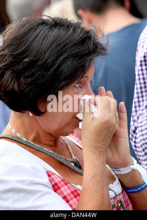 A woman wipes away her tears at a public viewing event during the announcement of the host of the 2018 Olympic Winter Games in Garmisch-Partenkirchen, Germany, 06 July 2011. The IOC chose Pyeongchang, South Korea. Photo: Karl-Josef Hildenbrand Stock Photo