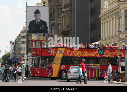 A tour bus with tourists passes through Friedrichstrasse and Checkpoint Charlie in Berlin, Germany, 5 July 2011. Berlin again has become a favourite tourist destination this summer counting more than six million overnight stays between January and April this year. This marks an increase of seven percent in comparison to last year. Photo: Sebastian Tanke Stock Photo