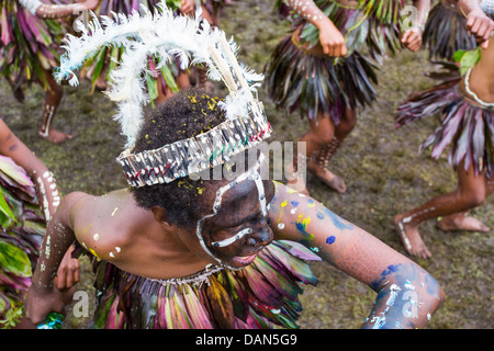 Children wearing traditional leaf costumes and dancing at the Goroka show in Papua New Guinea. Stock Photo