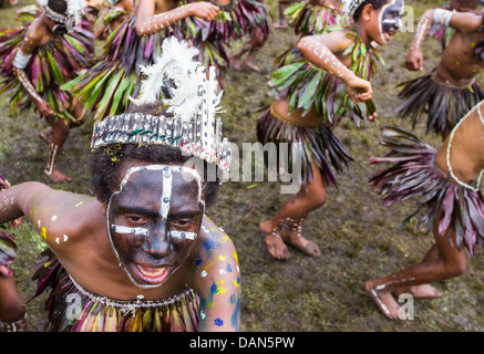 Children wearing traditional leaf costumes and dancing at the Goroka show in Papua New Guinea. Stock Photo