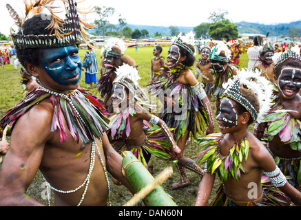 Children wearing traditional leaf costumes and dancing at the Goroka show in Papua New Guinea. Stock Photo