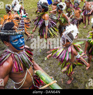 Children wearing traditional leaf costumes and dancing at the Goroka show in Papua New Guinea. Stock Photo