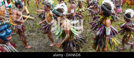 Children wearing traditional leaf costumes and dancing at the Goroka show in Papua New Guinea. Stock Photo