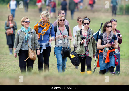 The Glastonbury Festival 2013 Festival goers walk from their tents to the festival site Stock Photo