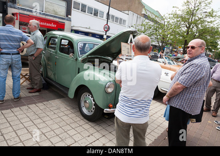 enthusiasts and visitors to town centre classic car show viewing 1949 ford prefect Stock Photo