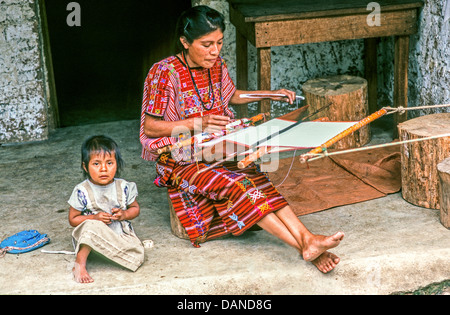 Young Mam Mayan mother using a backstrap loom on the porch of her home in the northwestern highlands of Guatemala. Stock Photo
