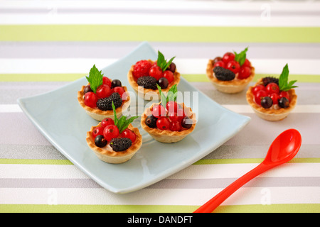 Wild berries tartlets. Recipe available. Stock Photo