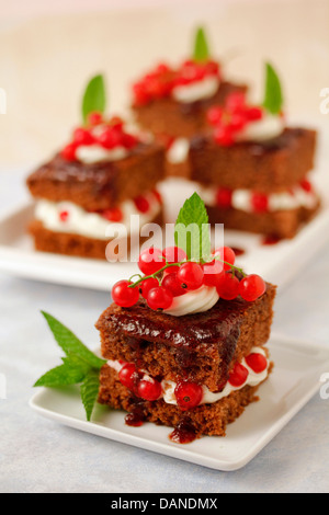 Chocolate sponge cakes with red currants. Recipe available. Stock Photo