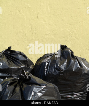 Pile of full black garbage bags outdoor Stock Photo