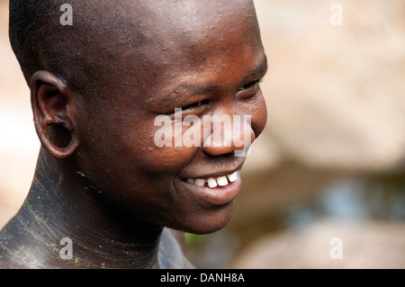 A Suri (Surma) naked young man body painted with mud, Ethiopia Stock