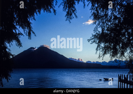 Lake Atitlan at sunrise from the northern shore with volcanoes Toliman and Atitlan and Cerro de Oro. Stock Photo