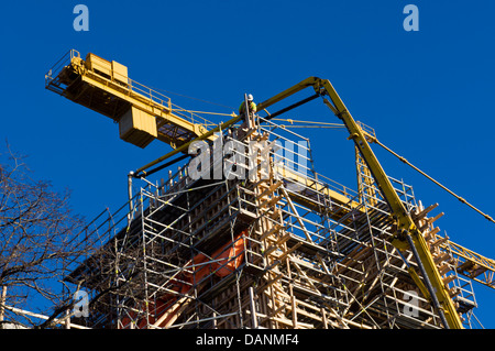 A truck pumps concrete into formwork high on the Halifax Central Library, Nova Scotia, Canada. Stock Photo