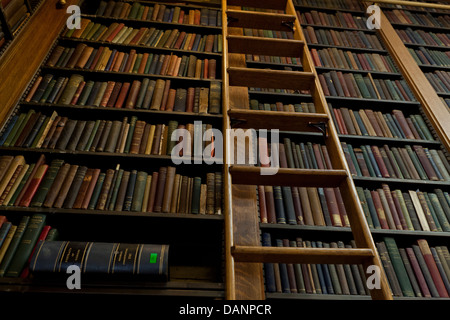 Vintage books on shelves in library  - USA Stock Photo