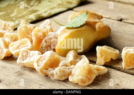 sugared ginger (candied) and fresh root on a wooden table Stock Photo