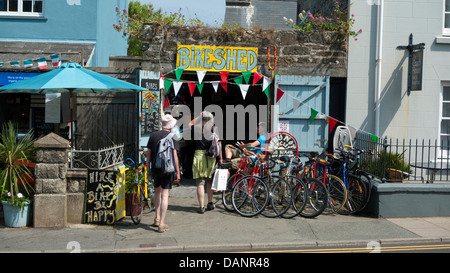 People looking at bikes for hire at the Bikeshed on HIgh Street in city of St. David's Pembrokeshire Wales UK   KATHY DEWITT Stock Photo