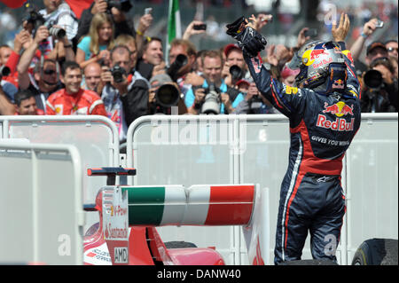 German Formula One driver Sebastian Vettel of Red Bull celebrates with the fans after he finished second in the race at the Silverstone race track in Northamptonshire, Great Britain, 10 July 2011. The Formula One Grand Prix of Great Britain is round nine of 19 races in 2011. Photo: David Ebener Stock Photo