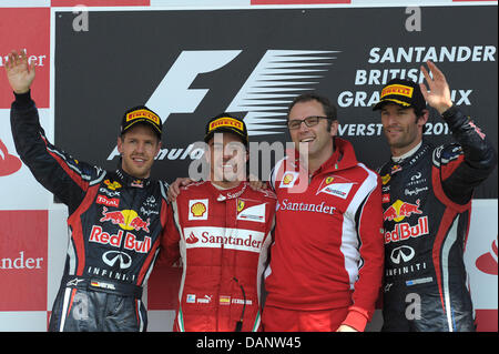 Winner Spanish Formula One driver Fernando Alonso (2nd L) of Scuderia Ferrari celebrates on the podium together with second placed German Sebastian Vettel (L) of Red Bull, third placed Australian Mark Webber (R) of Red Bull and Italian Stefano Domenicali, team manager of Ferrari, after the race at the Silverstone race track in Northamptonshire, Great Britain, 10 July 2011. The Form Stock Photo