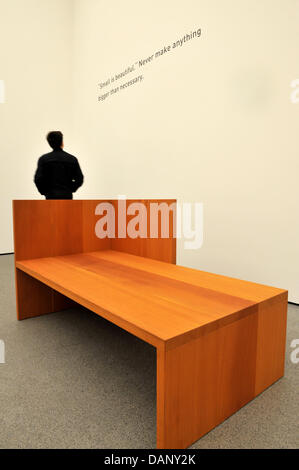 A man stands next to a bed by US artist Donald Judd (1928-1994) at the Pinakothek der Moderne in Munich, Germany, 14 July 2011. Judd's furniture was conceived to be used on a daily basis. Being one of the protagonists of Minimal Art, usage was among Judd's main concerns. From 15 July 2011, 'The New Collection - The International Design Museum Munich' presents a selection of Judd's 