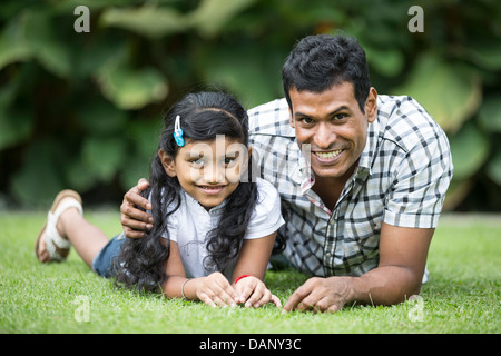 Happy Indian Father and daughter playing in the park. Lifestyle image. Stock Photo