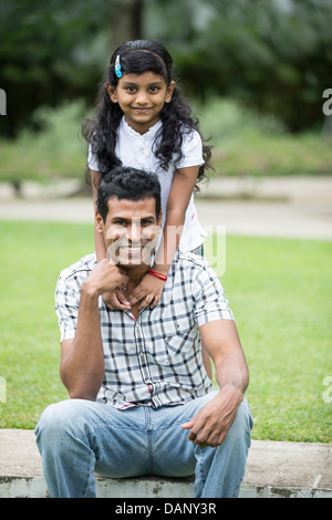 Happy Indian Father and daughter playing in the park. Lifestyle image. Stock Photo