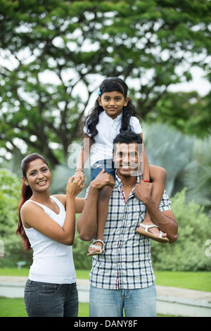 Happy Indian family. Father, mother and daughter in the park Stock Photo