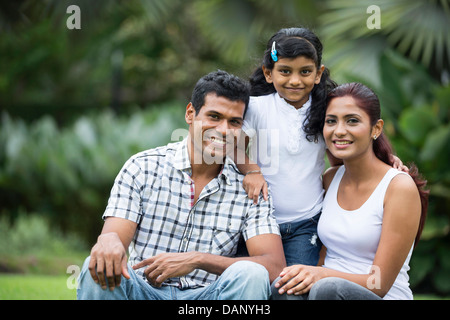 Happy Indian family. Father, mother and daughter in the park Stock Photo