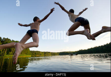 FILE - An archive picture, dated 05 July 2011, shows two boys jumping into the Treplin Lake near Treplin, Germany. Till 15 September 2011 water samples of bathing lakes are taken at least once a month for microbiological analyses to ensure good water quality for bathing. Photo: Patrick Pleul Stock Photo