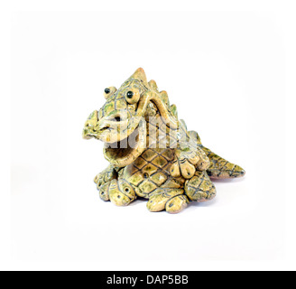 ceramic figurine of smiling yellow and green dragon - the symbol of 2012 year Stock Photo