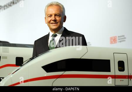 Deutsche Bahn CEO Ruediger Grube poses between miniature trains at the Bahn's semi-annual balance conference in Berlin, Germany, 28 July 2011. During the first half of 2011, the Deutsche Bahn transported more passengers than during any other semi-annual period before. Photo: Maurizio Gambarini Stock Photo